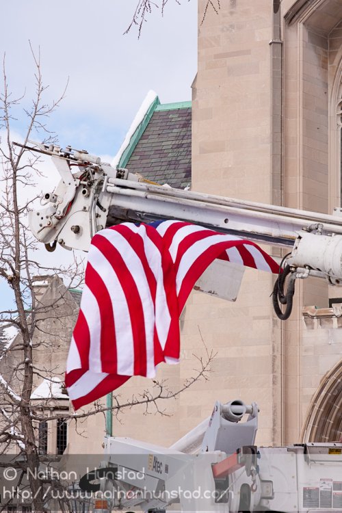 A flag hangs from a cherry picker in front of the House of Hope Presbyterian Church on Summit Avenue